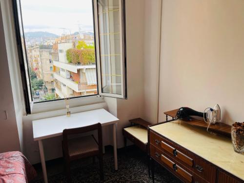 a room with a desk and a window with a view at MH Genova in Genoa
