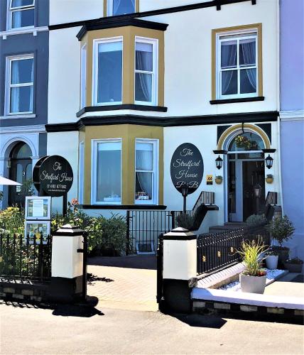 a building with signs on the front of it at Stratford House B & B in Llandudno
