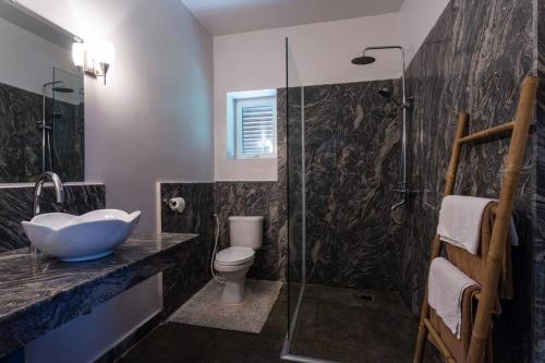 a bathroom with a sink and a toilet and a shower at Cozy Paradise in Battambang