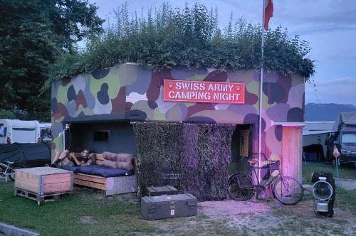 a couch sitting outside of a camping tent at Swiss Army Camping Night / Militärbunker in Sankt Margrethen