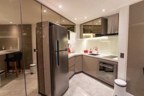 a kitchen with a stainless steel refrigerator at Particular Deluxe Iate Plaza in Fortaleza