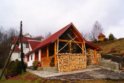 a large house with a red roof at Rakhiv Plai in Rakhiv