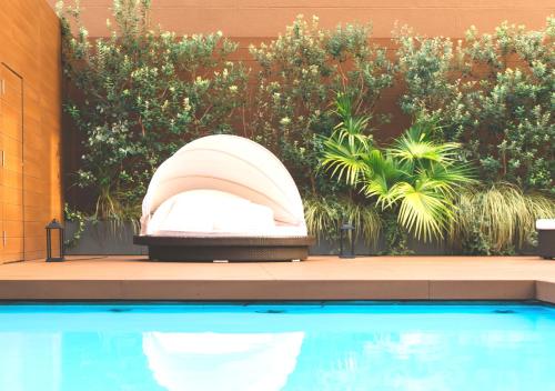 a pool with a large white object next to a fence at Oriental Hotel Fukuoka Hakata Station in Fukuoka