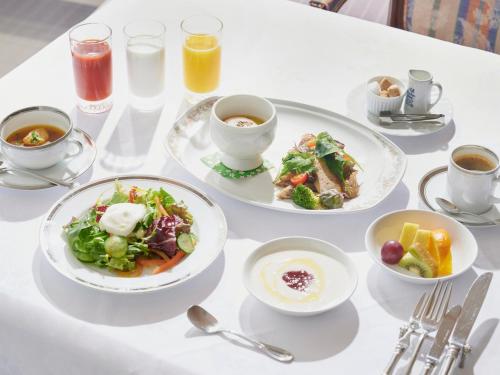 a table with plates of food and cups of coffee at Bettei Amafuru Oka in Ibusuki