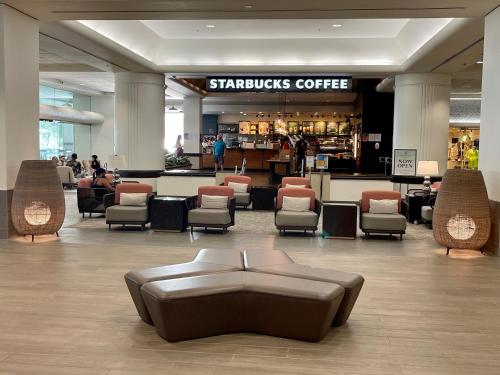a lobby with a couch and chairs in a store at Ala Moana Hotel 31st floor in Honolulu
