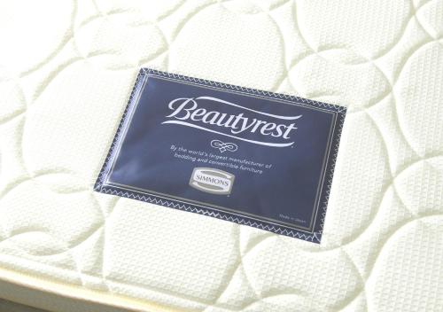 a box of beaumont biscuits on a bed at Oriental Hotel Fukuoka Hakata Station in Fukuoka