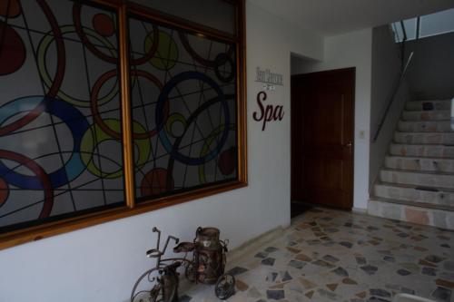 a room with a stained glass window and a staircase at Hotel San Marcos in Paipa