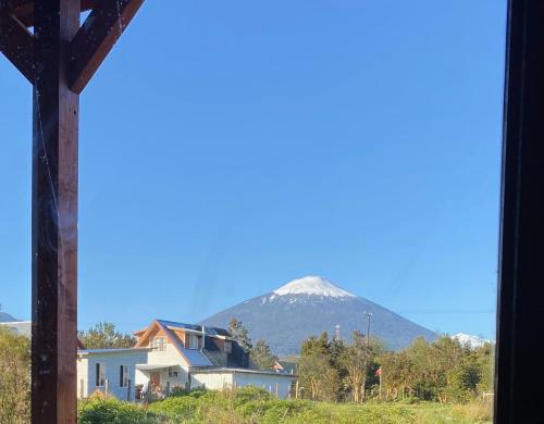 a view from a house with a mountain in the background at Rio Blanco in Hornopiren