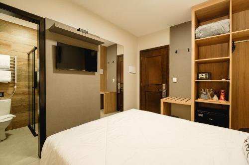 Postel nebo postele na pokoji v ubytování Malbec Casa Hotel