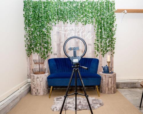 a camera on a tripod next to a blue chair with a plant at Once-In-A-Lifetime Coffee-Themed Stay For Up To 8 in Clarksville