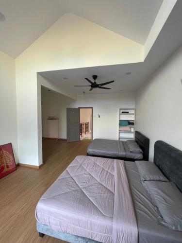 a bedroom with two beds and a ceiling fan at Austin Perdana 5mins to AICC Opposite HSI in Johor Bahru
