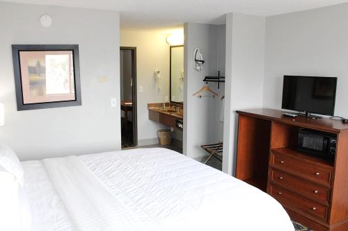 Una televisión o centro de entretenimiento en Greenlight Inn & Suites St James