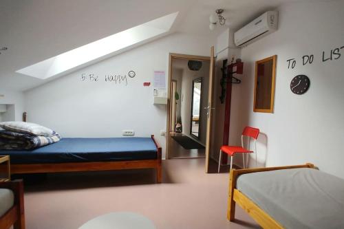 a bedroom with a bed and a room with a window at Goodlebang, 3 bed room apartment, Center Ljubljana in Ljubljana