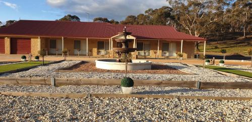 a building with a fountain in front of a house at Alma Retreat, King bed, Family, Pet Friendly in Alma