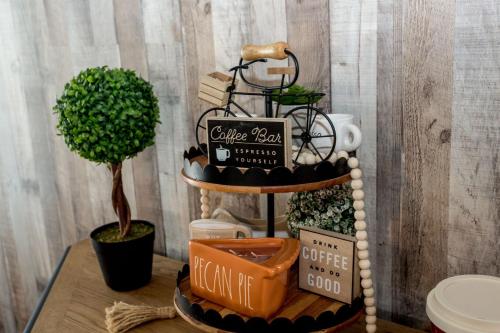 a table with a shelf with a bike on it at Once-In-A-Lifetime Coffee-Themed Stay For Up To 8 in Clarksville