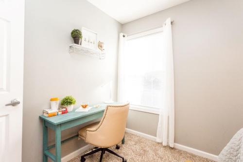 a desk with a chair in a room with a window at Once-In-A-Lifetime Coffee-Themed Stay For Up To 8 in Clarksville
