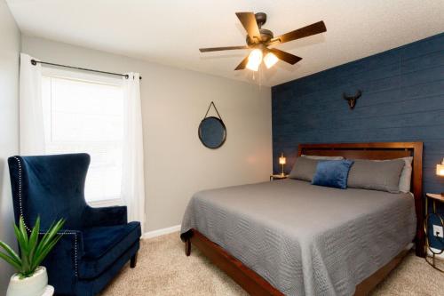 a bedroom with a bed and a ceiling fan and a chair at Once-In-A-Lifetime Coffee-Themed Stay For Up To 8 in Clarksville