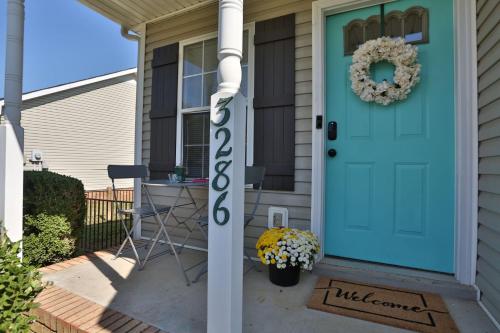 a turquoise door with a wreath on a house at Once-In-A-Lifetime Coffee-Themed Stay For Up To 8 in Clarksville