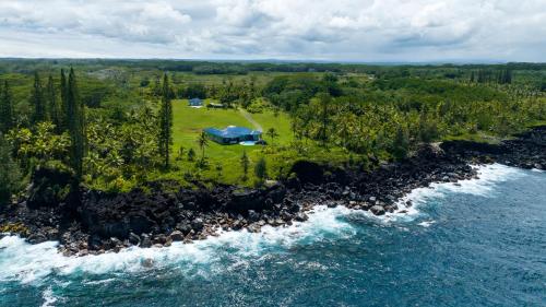 an aerial view of a tent on a island next to the water at Wild Blue Water in Pahoa