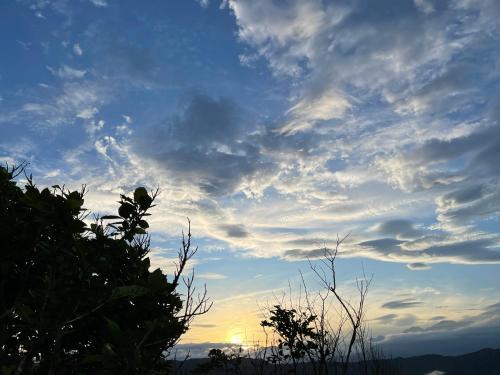 a cloudy sky with the sun in the background at Zephyr Homestay in Yanliau