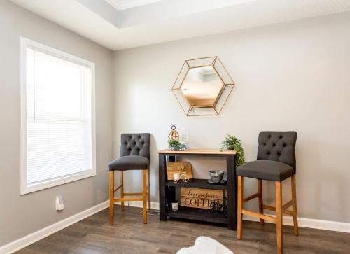 two chairs in a room with a mirror at Once-In-A-Lifetime Coffee-Themed Stay For Up To 8 in Clarksville
