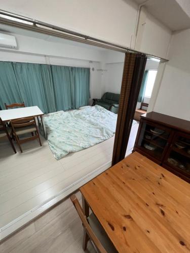 a small room with a bed and a table at G&R House302 in Tokyo