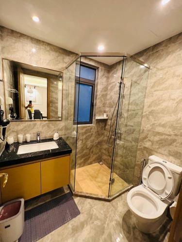 a bathroom with a shower and a toilet and a sink at R&F PRINCESS COVE at ANJU in Johor Bahru