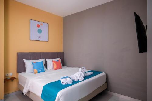 a bedroom with two beds with stuffed animals on them at Sans Hotel Fourth Loft Solo in Solo