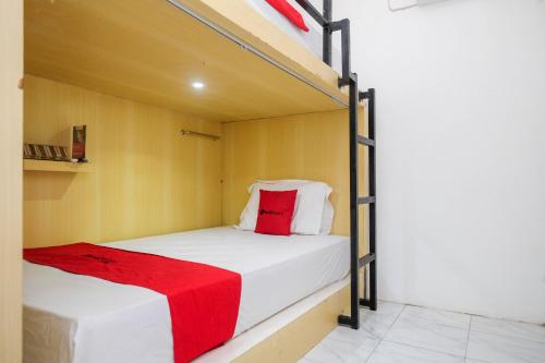 a bedroom with two bunk beds with a red pillow at RedDoorz Hostel near Lawang Sewu Semarang in Kalibanteng-lor