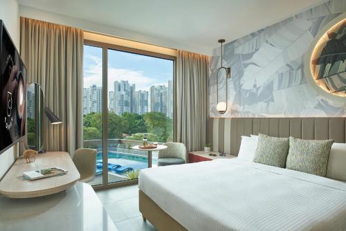 a hotel room with a bed and a view of a pool at Citadines Connect Rochester Singapore in Singapore