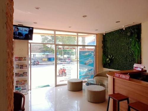 a restaurant with a table with stools and a television at Marina Seaview Krabi in Krabi town