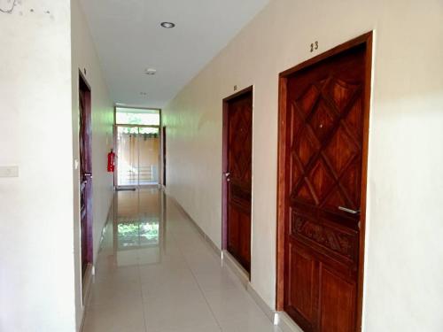 an empty hallway with a wooden door and a corridor at Marina Seaview Krabi in Krabi town