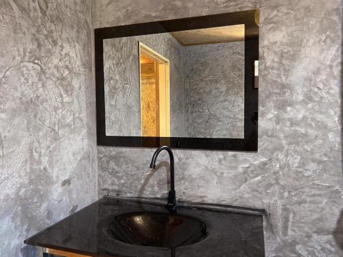 a bathroom with a sink and a mirror at Sunrise House in Ko Yao Noi