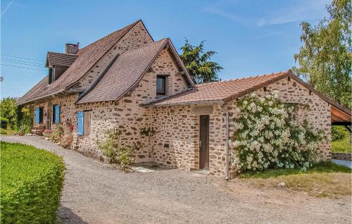 a large stone house with a roof at Amazing Home In St Priest La Fougeres in La Coquille