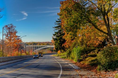 a car driving down a road with a bridge at Niagara River&Gorgeview Manor-10MinsWalkToFalls in Niagara Falls