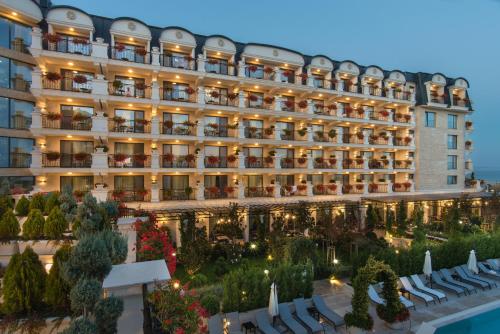 an aerial view of a hotel with chairs and trees at Casa di Fiore SPA and Medical Hotel, Mineral Pools & Private Beach in Kranevo