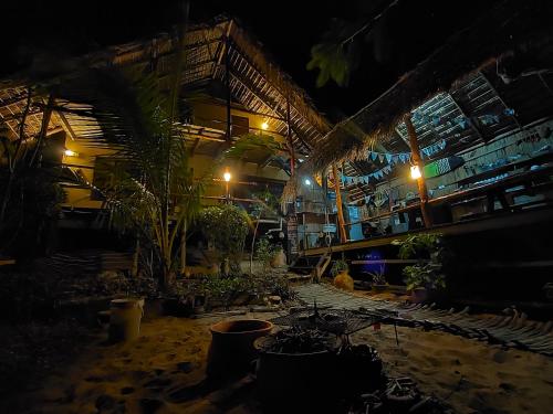 a patio at night with a bunch of plants at Casa Surf Lodge - Tofo in Praia do Tofo