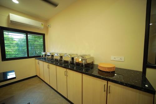 a kitchen with a counter with pots and pans at Majestic Hotel in Madurai