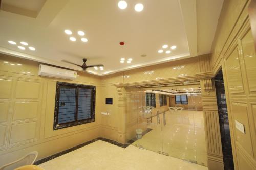 a large room with a window and a glass wall at Majestic Hotel in Madurai