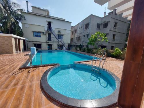 a large swimming pool in the middle of a building at ICONIC Hotel Digha in Digha
