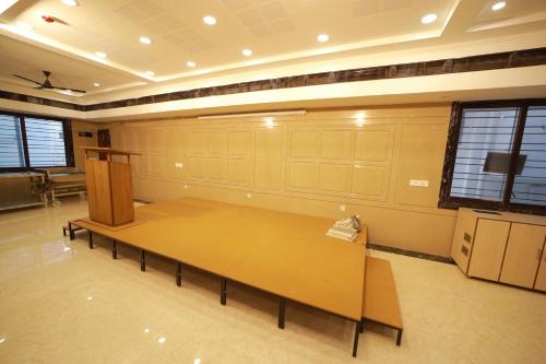 a large room with a table in the middle of it at Majestic Hotel in Madurai