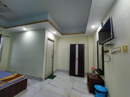 a room with a tv and a bed in a room at ICONIC Hotel Digha in Digha