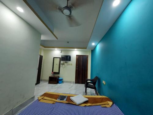 a room with a bed and a blue wall at ICONIC Hotel Digha in Digha