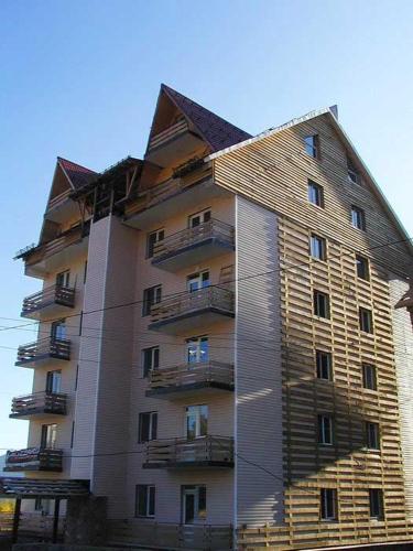 a tall apartment building with a roof at gudauri in Gudauri