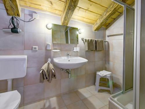 a bathroom with a sink and a mirror at Apartment in Lienz with a balcony in Obernussdorf