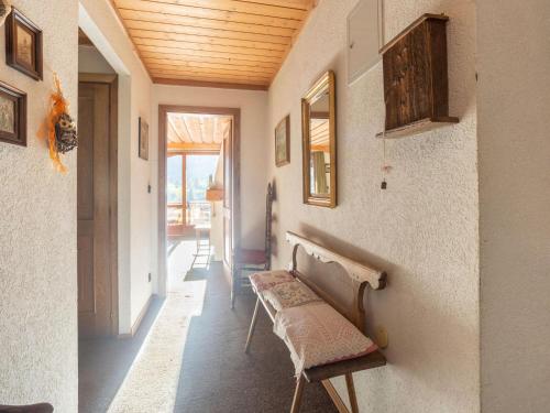 a hallway with a bench in a room with a wooden ceiling at Centrally Located Apartment in Bad Kleinkirchheim in Bad Kleinkirchheim