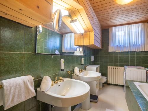 a bathroom with two sinks and a toilet at Centrally Located Apartment in Bad Kleinkirchheim in Bad Kleinkirchheim