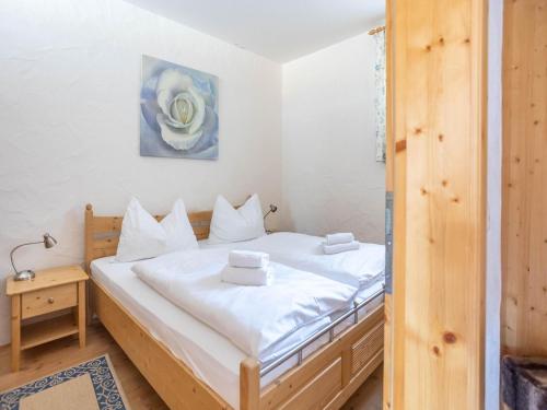 a bedroom with a bed with white sheets at Apartment in Bad Kleinkirchheim in ski area in Bad Kleinkirchheim