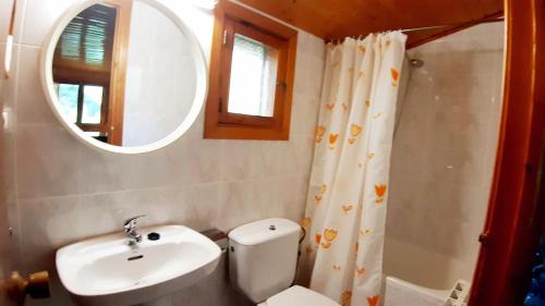 a bathroom with a toilet and a sink and a mirror at Casitas La Purísima Lavanda in Requena