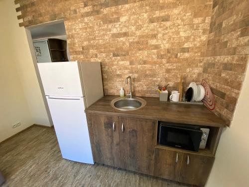 a small kitchen with a sink and a refrigerator at Двокімнатні апартаменти в ЖК Щасливий Запорізьке шосе 30 in Dnipro
